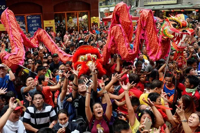 People scramble for candy outside a grocery during Chinese Lunar New Year celebrations in Manila's Chinatown, Philippines January 28, 2017. (Photo by Ezra Acayan/Reuters)