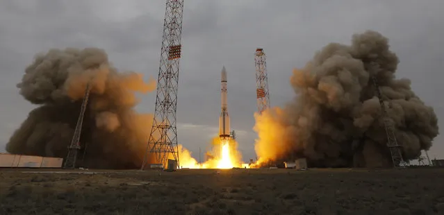 The Proton-M rocket booster blasts off at the Russian leased Baikonur cosmodrome, Kazakhstan, Monday, March 14, 2016. Europe and Russia launched a joint mission Monday to explore the atmosphere of Mars and hunt for signs of life on the red planet. The unmanned ExoMars probe, a collaboration between the European Space Agency and Roscosmos, took off aboard a Russian rocket and is expected to reach Mars in October. (Photo by Dmitri Lovetsky/AP Photo)