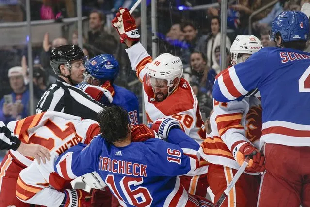 Players fight during the second period an NHL hockey game between the New York Rangers and the Calgary Flames on Monday, February 12, 2024, in New York. (Photo by Bryan Woolston/AP Photo)