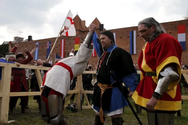 English fighter Pawel Kurzak (L) reacts as he is declared winner in his pole arm duel with Spanish fighter Jose Amoedo during the Medieval Combat World Championship at Malbork Castle, northern Poland, April 30, 2015. (Photo by Kacper Pempel/Reuters)
