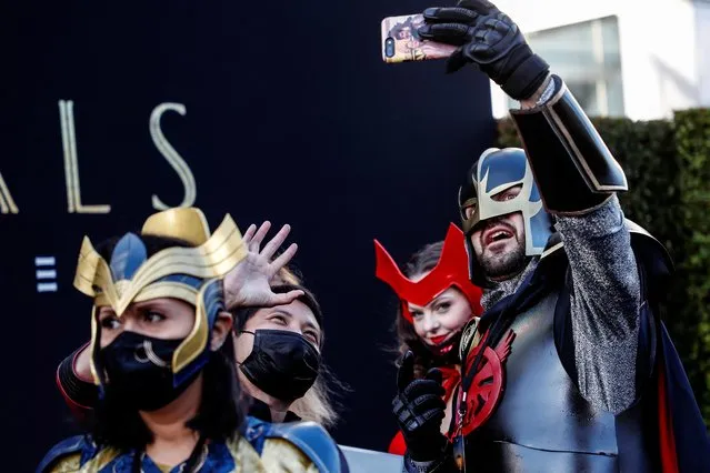 Costumed fans pose for photos ahead of the premiere for the film “Eternals” in Los Angeles, California, U.S. October 18, 2021. (Photo by Mario Anzuoni/Reuters)