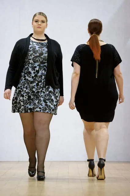 Models wear a design created by Plus Size Fashion during London Fashion Week Autumn/Winter 2014, at Vinopolis in central London, Friday, February 14, 2014. (Photo by Jonathan Short/AP Photo)