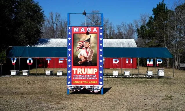 Signage supporting former US President and 2024 presidential hopeful Donald Trump stands at the Ferris Apiaries beekeeper in Yemassee, South Carolina on February 21, 2024 . (Photo by Timothy A. Clary/AFP Photo)