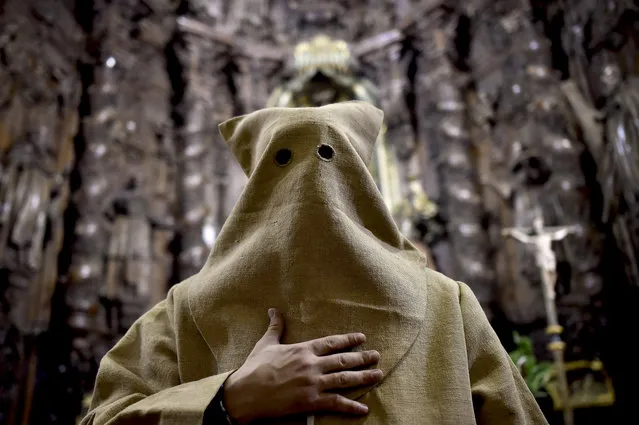 An “Ensacado”,' or masked penitent, takes part in the procession of the “Silencio del Santisimo Cristo del Rebate” brotherhood, during Holy Week in Tarazona, northern Spain, Tuesday, March 22, 2016. (Photo by Alvaro Barrientos/AP Photo)