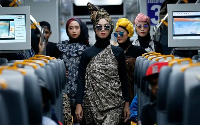 Models perform during a Muslim fashion show an airport train in Jakarta, Indonesia on Thursday, May 2, 2019. The fashion show was held to great to upcoming fasting month of Ramadan, the holiest month in Muslim calendar. (Photo by Tatan Syuflana/AP Photo)