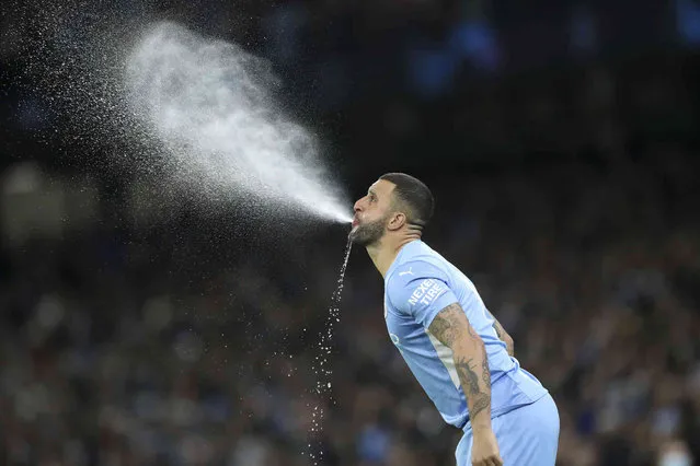 Manchester City's Kyle Walker performs his traditional blow out of a drink before the Champions League group A soccer match between Manchester City and Paris Saint-Germain at the Etihad Stadium in Manchester, England, Wednesday, November 24, 2021. (Photo by Scott Heppell/AP Photo)