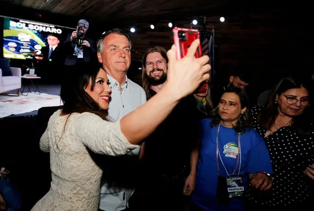 Former Brazilian President Jair Bolsonaro poses for a selfie during an event taking place in a restaurant at Dezerland amusement park in Orlando, Florida, U.S. January 31, 2023. (Photo by Joe Skipper/Reuters)