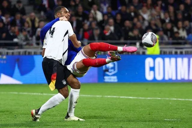 Germany's defender #04 Jonathan Tah (L) fights for the ball with France's forward #09 Olivier Giroud (behind) during the friendly football match between France and Germany, at the Groupama Stadium in Decines-Charpieu, near Lyon, on March 23, 2024. (Photo by Franck Fife/AFP Photo)