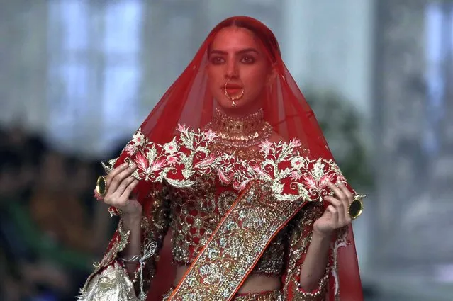 A model presents a creation during Bridal Couture Week, in Lahore, Pakistan, Saturday, December 11, 2021. (Photo by K.M. Chaudary/AP Photo) 