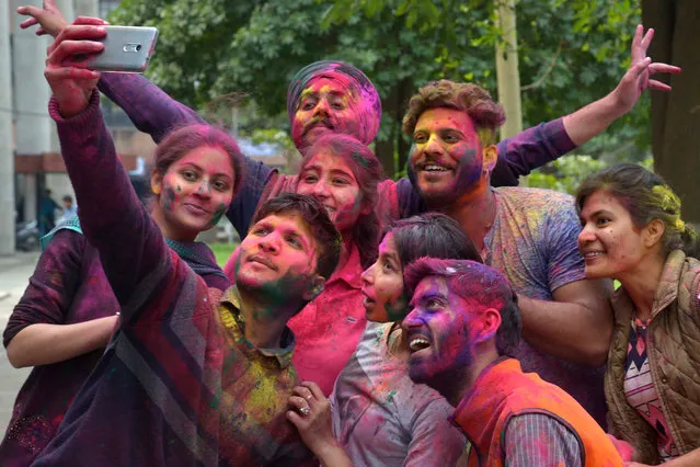Indian students take a selfie as they celebrate the Holi festival with coloured powder at Guru Nanak Dev University in Amritsar on March 10, 2017. (Photo by Narinder Nanu/AFP Photo)