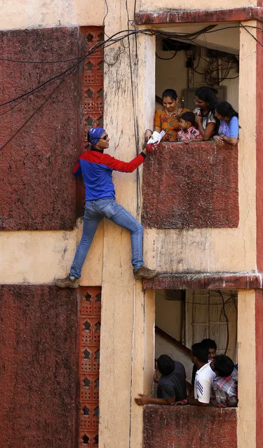 Independant candidate Gaurav Sharma, a martial arts trainer who has come to be known as the Indian spiderman, climbs a building to distribute campaign pamphlets to residents for the ongoing national election in Mumbai, India, Friday,  April 11, 2014. The multiphase voting across the country runs until May 12, with results for the 543-seat lower house of Parliament announced May 16. (Photo by Rajanish Kakade/AP Photo)