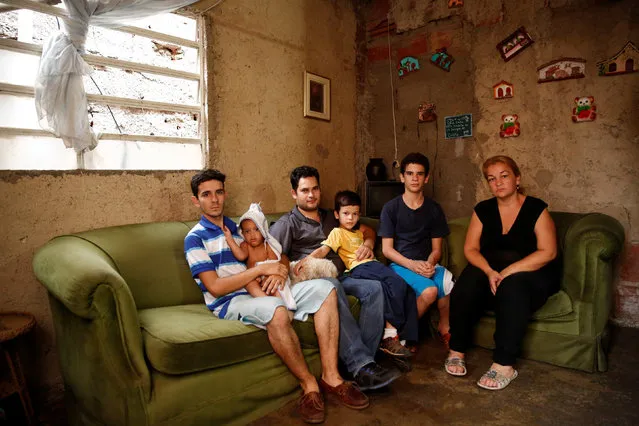 Yunni Perez (R) poses for a picture next to her relatives (L-R) Carlos Acosta, Adrian Gonzalez, Luis Oliveros, Luis Oliveros and Hector Acosta at their home in Caracas, Venezuela April 22, 2016. (Photo by Carlos Garcia Rawlins/Reuters)