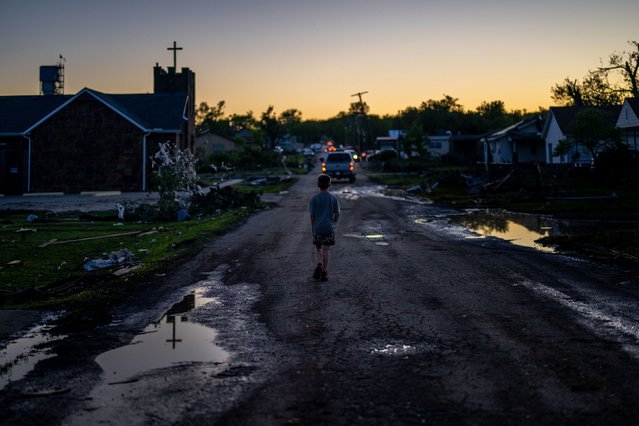 A child walks through a tornado-damaged neighborhood in Barnsdall, Oklahoma, on Tuesday, May 7, 2024. (Photo by Brandon Bell/Getty Images)
