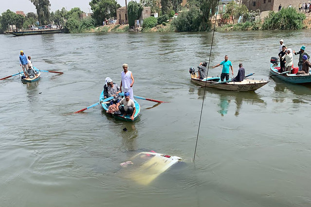 Rescuers work to pull a sunken minibus from a canal of the Nile River near Abu Ghaleb village in Egypt's Giza governorate on May 21, 2024. At least 10 farm workers died in Egypt when a minibus plunged off a river ferry and into the Nile northwest of Cairo on May 21, the health ministry said. (Photo by AFP Photo/Stringer)