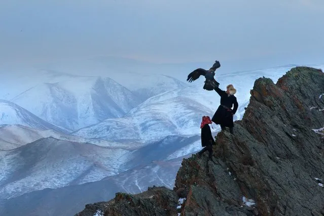 13 year old Irka Bolen with his eagle. Tradition wise, when a boy turns 13, then are strong enough to hold the weight of a fully grown eagle. (Photo by Asher Svidensky/Caters News)