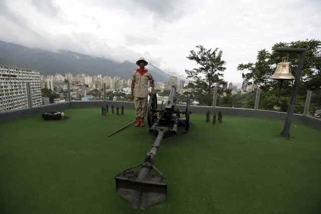 A Venezuelan soldier charged to fire a cannon in at 4:25 p.m., the time the death of Venezuela's late president Hugo Chavez was announced, poses for a picture at the 4F military fort in Caracas, June 30, 2015. The cannon is fired daily to commemorate Chavez’s death in 2013. (Photo by Jorge Dan Lopez/Reuters)