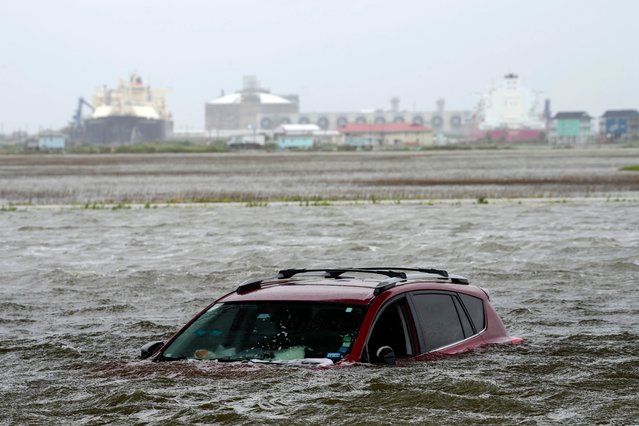 A car sits submerged in water as Tropical Storm Alberto approaches land Wednesday, June 19, 2024, in Surfside Beach, Texas. (Photo by Jon Shapley/Houston Chronicle via AP Photo)