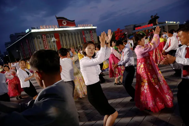People participate in a mass dance in the capital's main ceremonial square, a day after the ruling Workers' Party of Korea party wrapped up its first congress in 36 years, in Pyongyang, North Korea, May 10, 2016. (Photo by Damir Sagolj/Reuters)