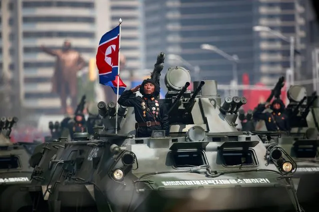 North Korean soldiers on military armoured vehicles drive past during a parade for the “Day of the Sun” festival on Kim Il Sung Square in Pyongyang, North Korea, 15 April 2017. North Koreans celebrate the “Day of the Sun” festival commemorating the 105th birthday anniversary of former supreme leader Kim Il-sung on 15 April as tension over nuclear issues rise in the region. (Photo by How Hwee Young/EPA)