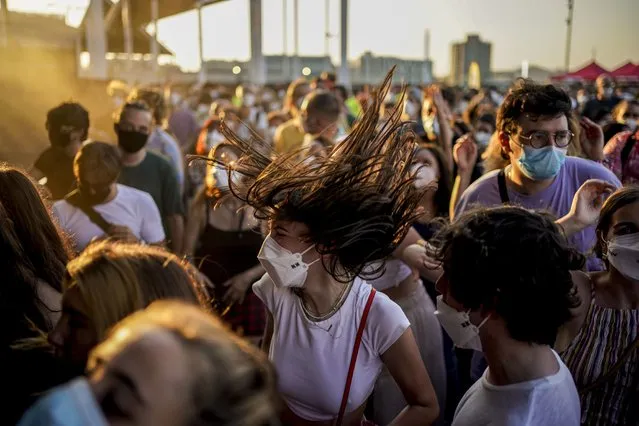 People dance during the Cruilla music festival in Barcelona, Spain, Friday, July 9, 2021. (Photo by Joan Mateu/AP Photo)