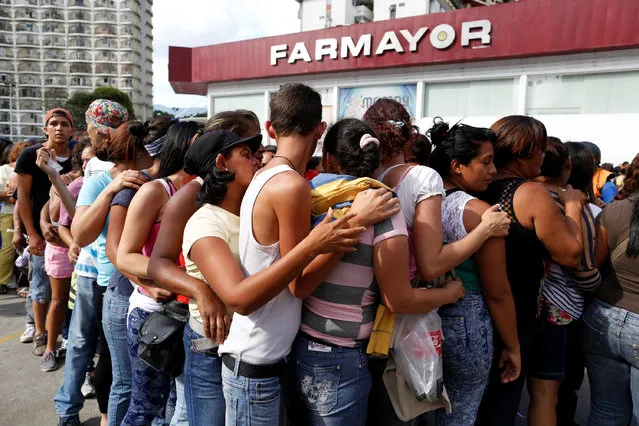 People line up to try to buy toilet paper and diapers outside a pharmacy in Caracas May 16, 2016. (Photo by Carlos Garcia Rawlins/Reuters)