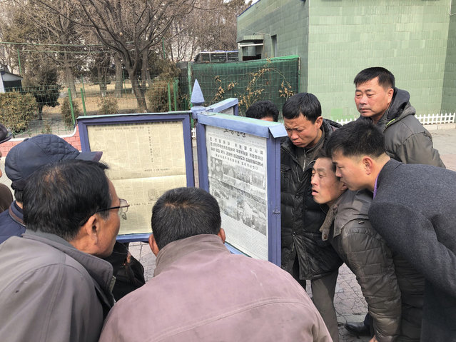 In this Wednesday, February 27, 2019, photo, men gather around the public newspaper posts to read about North Korean leader Kim Jong Un's visit to Vietnam for the second summit with U.S. President Donald Trump, in Pyongyang, North Korea. North Koreans have been getting a quicker, more polished look at their leader as he meets with Trump in Hanoi in their second summit. But one thing hasn’t changed at all – North Korea’s media have one story to tell, and it’s always about the infallibility of the glorious leader. (Photo by AP Photo/Stringer)