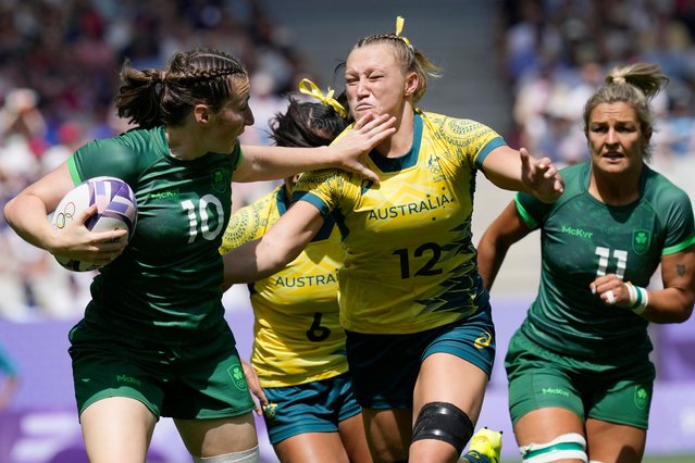 Ireland's Eve Higgins, left, fends off the challenge of Australia's Maddison Levi, during the women's Pool B Rugby Sevens match between Australia and Ireland at the 2024 Summer Olympics, in the Stade de France, in Saint-Denis, France, Monday, July 29, 2024. (Photo by Tsvangirayi Mukwazhi/AP Photo)