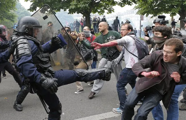 Riot police officers clash with protestors during a demonstration held as part of nationwide labor actions in Paris, France, Thursday, May 26, 2016. French protesters scuffled with police, dock workers set off smoke bombs and union activists disrupted fuel supplies and nuclear plants Thursday in the biggest challenge yet to President Francois Hollande's government as it tries to give employers more flexibility. (Photo by Francois Mori/AP Photo)