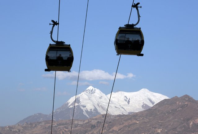 Cable cars are pictured in front of the Illimani mountain, in La Paz, July 23, 2015. (Photo by David Mercado/Reuters)