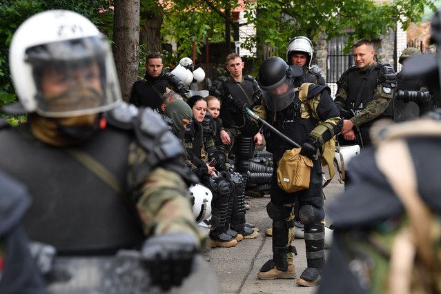 Soldiers of NATO-led international peacekeeping Kosovo Force (KFOR) prepare their gear in front of the building of the municipality in Zvecan, Kosovo, 29 May 2023. At least ten people were injured in violence between Kosovo police and ethnic Serbs in the town of Zvecan on 26 May, after protesters gathered outside state buildings while Albanian mayors were heading to assume office. (Photo by Georgi Licovski/EPA/EFE)