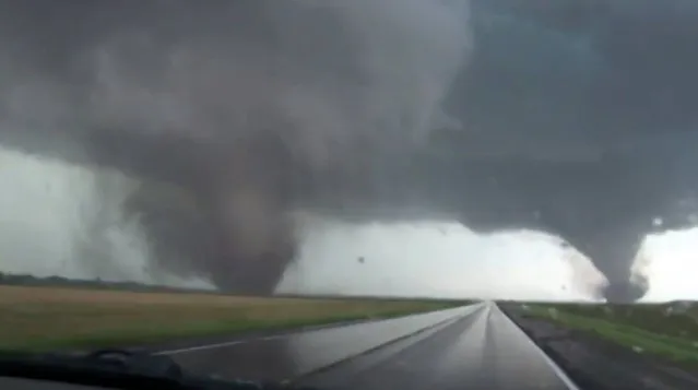 This framgrab taken from video provided by StormChasingVideo.com shows two tornados approaching Pilger, Neb., Monday June 16, 2014. The National Weather Service said at least two twisters touched down within roughly a mile of each other Monday in northeast Nebraska. (Photo by AP Photo/StormChasingVideo.com)
