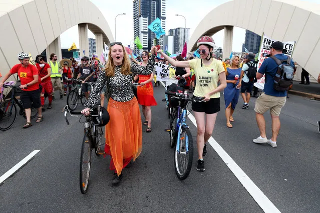 Protesters march during an Extinction Rebellion rally from Kurilpa Park to William Jolly Bridge in Brisbane, Australia, 13 December 2019. (Photo by David Clark/EPA/EFE)