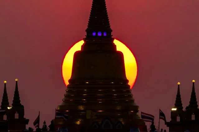 The sun sets behind Wat Saket Temple, or Golden Mount in Bangkok, Thailand, March 15, 2022. (Photo by Athit Perawongmetha/Reuters)