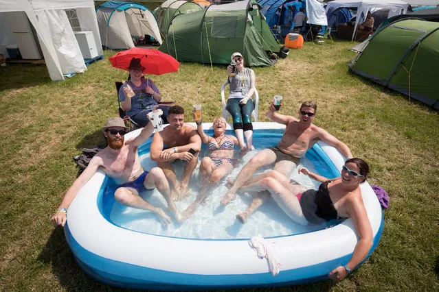 Camping field stewards use a paddling pool as people arrive at the Glastonbury Festival amid heightened security at Worthy Farm in Pilton on June 21, 2017 near Glastonbury, England. The largest greenfield festival in the world Glastonbury Festival is now a five-day festival of contemporary performing arts. The Somerset Festival, which Michael Eavis started in 1970 when several hundred hippies paid just £1, now attracts more than 175,000 people. (Photo by Matt Cardy/Getty Images)