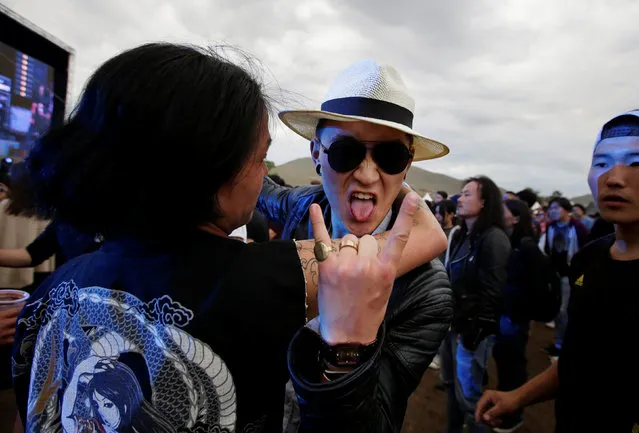 A reveller gestures at the Play Time 2016 music festival on the outskirts of Ulaanbaatar, Mongolia, June 26, 2016. (Photo by Jason Lee/Reuters)