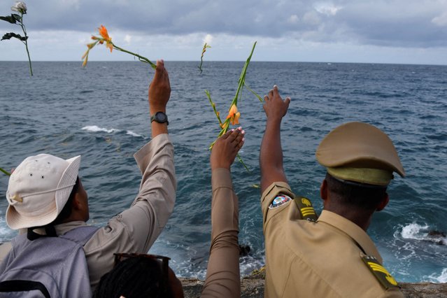 People throw flowers during a ceremony to honour late rebel hero Camilo Cienfuegos, who went missing during a flight on this day in 1959, in Havana, Cuba, on October 28, 2024. (Photo by Norlys Perez/Reuters)