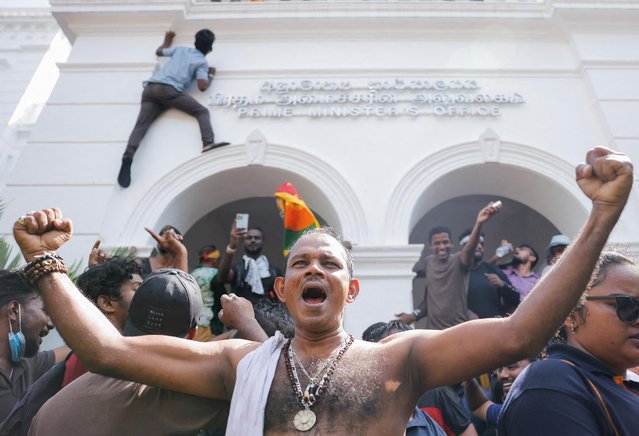 Demonstrators celebrate after they entered into Sri Lankan Prime Minister Ranil Wickremasinghe's office during a protest demanding for his resignation, after President Gotabaya Rajapaksa fled, amid the country's economic crisis, in Colombo, Sri Lanka, July 13, 2022. (Photo by Dinuka Liyanawatte/Reuters)