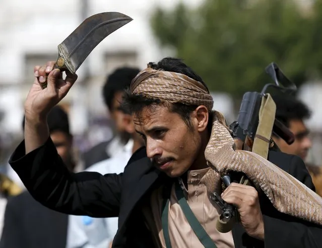 A Houthi follower carries his rifle and waves a dagger as he dances the traditional Baraa dance ahead of a demonstration against the Saudi-led air strikes in Yemen's capital Sanaa August 24, 2015. (Photo by Khaled Abdullah/Reuters)