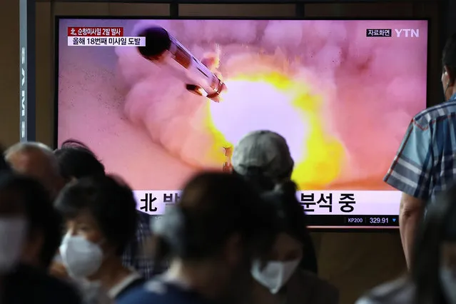 People watch a television screen showing a file image of a North Korean missile launch at the Seoul Railway Station on August 17, 2022 in Seoul, South Korea. North Korea test-fired two cruise missiles toward the Yellow Sea on Wednesday, a South Korean military official said, as President Yoon Suk-yeol held a press conference to mark the 100th day since taking office. (Photo by Chung Sung-Jun/Getty Images)