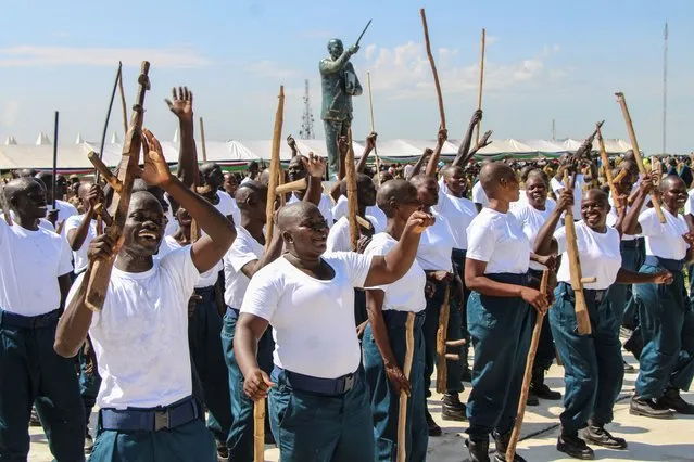 New members of the National Police Services of the Unified Forces who have been on training since the implementation of the revitalized peace agreement in 2018 react during their graduation ceremony at Dr. John Garang Mausoleum in Juba on August 30, 2022.. Thousands of fighters including former rebels from rival camps in South Sudan's civil war were integrated into the country's army in a long-overdue graduation ceremony. (Photo by Peter Louis Gume/AFP Photo)