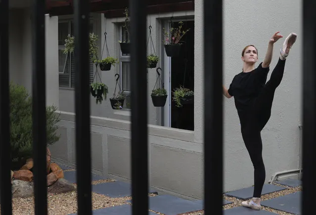 Cape Town City Ballet dancer Olivia Parfitt, trains at her apartment in Cape Town, South Africa, Saturday, May 2, 2020. All members of the company are forced to practice at their homes during the government lockdown to control the spread of coronavirus. (Photo by Nardus Engelbrecht/AP Photo)