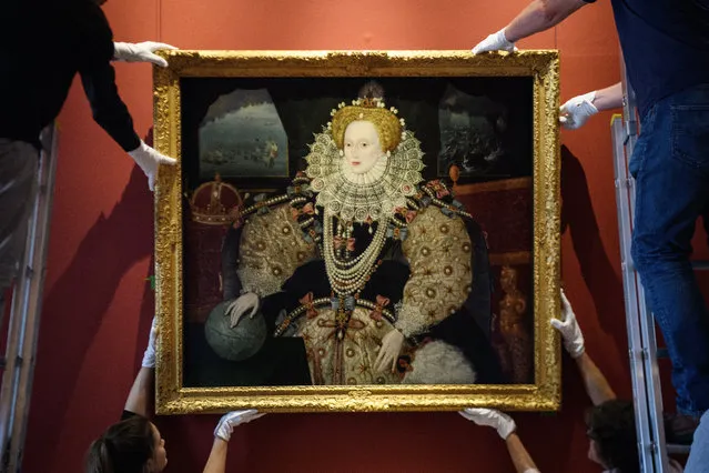 Gallery assistants pose with the “Armada Portrait of Elizabeth I” oil painting as it is unveiled following extensive cleaning at the Queen's House, Greenwich on October 12, 2017 in London, England. Painted in the early 1590s, the uncredited painting was aquired for the nation in 2016 and has since undergone lengthy conservation to restore the work to it's original colours. (Photo by Leon Neal/Getty Images)