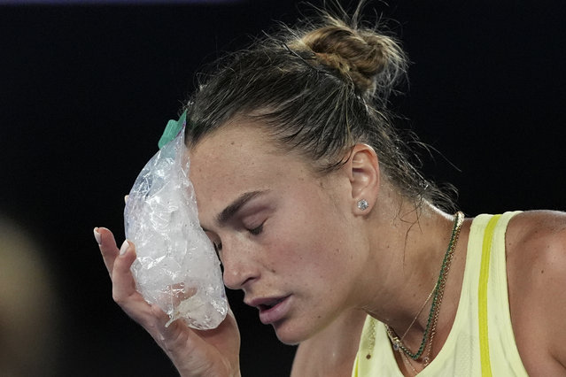 Aryna Sabalenka of Belarus places a bag of ice to her face during her semifinal match against Paula Badosa of Spain at the Australian Open tennis championship in Melbourne, Australia, Thursday, January 23, 2025. (Photo by Ng Han Guan/AP Photo)