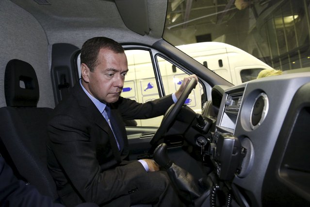 Russian Prime Minister Dmitry Medvedev inspects a vehicle as he visits the international specialized exhibition “Import substitution” outside Moscow, Russia, September 15, 2015. (Photo by Dmitry Astakhov/Reuters/RIA Novosti)