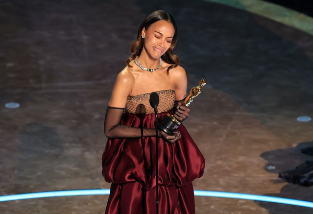 Saldaña accepts the best supporting actress Oscar on Sunday, March 2, 2025. She won for her role in “Emilia Pérez” and dedicated her Oscar to her grandmother, noting that she is a proud child of immigrant parents. “The fact that I am getting an award for a role where I got to sing and speak in Spanish? My grandmother, if she were here, would be so delighted”. (Photo by Kevin Winter/Getty Images)