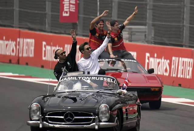 Mercedes driver Lewis Hamilton, of Britain, and teammate George Russell, of Britain, front car, and Ferrari driver Carlos Sainz, of Spain, and teammate Charles Leclerc, of Monaco, rear car, wave to the crowd during the parade prior the start of the the Formula One Mexico Grand Prix auto race at the Hermanos Rodriguez racetrack in Mexico City, Sunday, October 30, 2022. (Photo by Eduardo Verdugo/AP Photo)