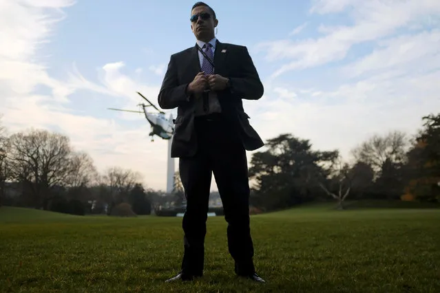 A Secret Service agent stands guard on the South Lawn as U.S. President Donald Trump departs the White House aboard Marine One for New York in Washington, U.S., December 2, 2017. (Photo by James Lawler Duggan/Reuters)