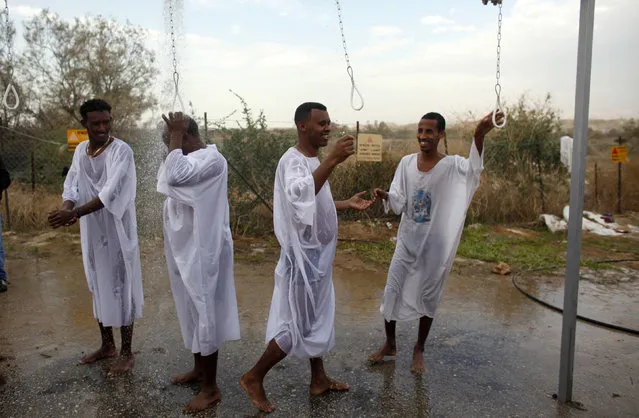 Christian pilgrims wash themselves during a ceremony at the baptismal site known as Qasr el-Yahud on the banks of the Jordan River near the West Bank city of Jericho January 18, 2011. (Photo by Nir Elias/Reuters)