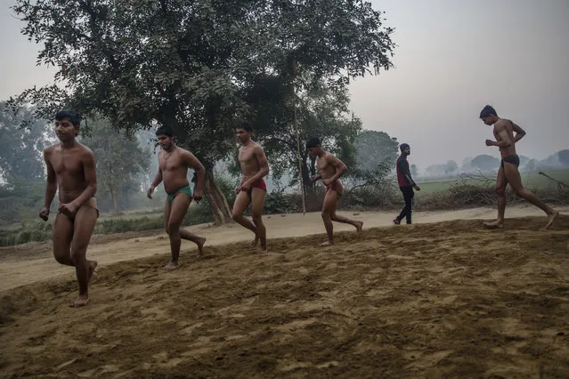 In this November 22, 2017 photo, Indian Kushti wrestlers practice during a training session, at an akhada, a kind of wrestling hostel at Bahadurgarh, in Haryana, India. (Photo by Dar Yasin/AP Photo)