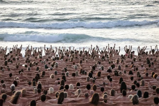 People stand naked as part of artist Spencer Tunick's art installation to raise awareness of skin cancer and encourage people to have their skin checked, at Bondi Beach in Sydney, Australia on November 26, 2022. (Photo by Loren Elliott/Reuters)